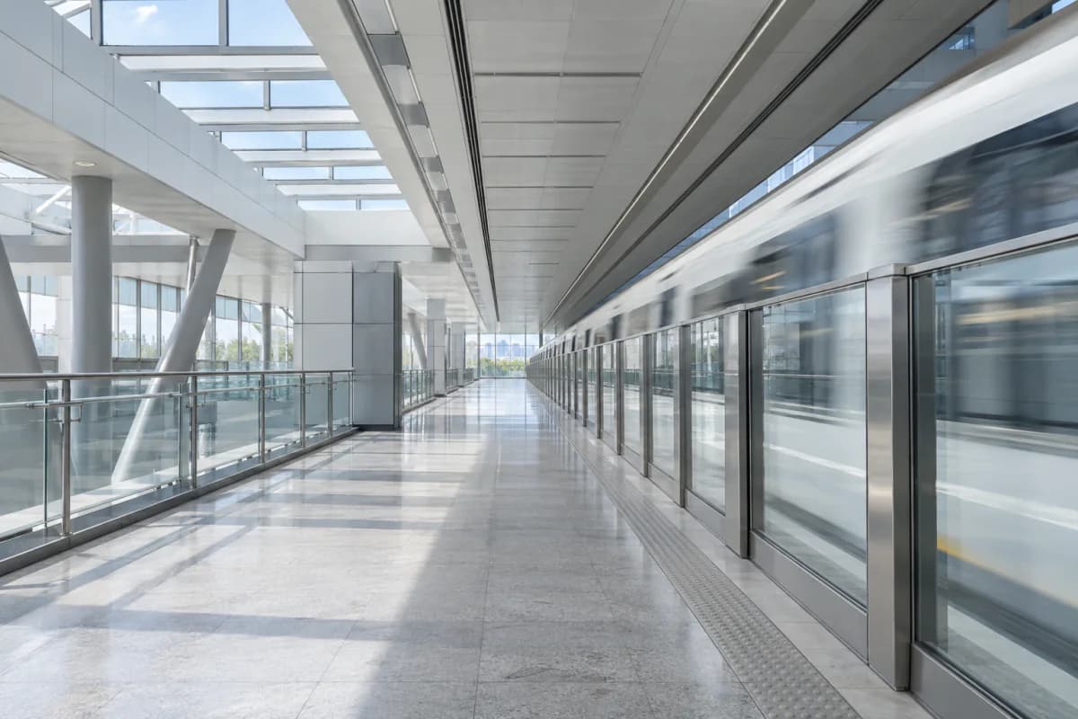 A bright, empty metro platform as a driverless train glides in